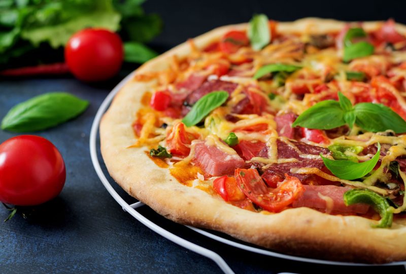 Pizza with salami, ham, tomato, cheese and mushrooms Pizza with salami, ham, tomato, cheese and mushrooms